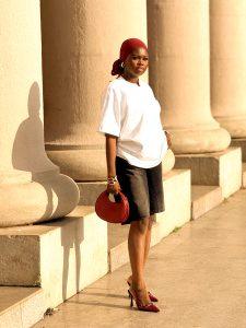 Denim jorts paired with an oversized white T-shirt, wine-coloured shoes, scarf and bag.