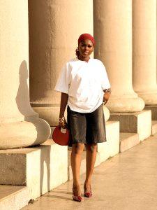 Denim jorts paired with an oversized white T-shirt, wine-coloured shoes, scarf and bag.