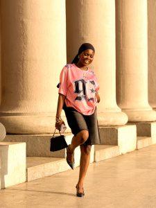Sporty jorts outfit styled with a jersey, black shoes, scarf and bag