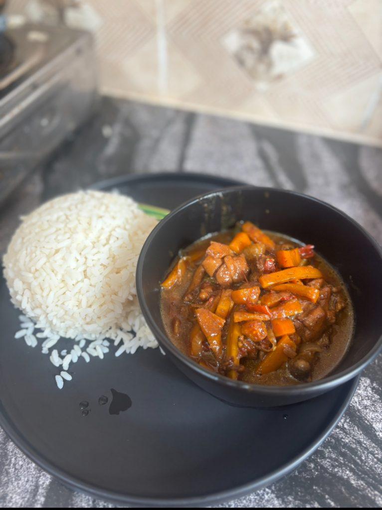 Hot bowl of white rice and steaming chicken sauce